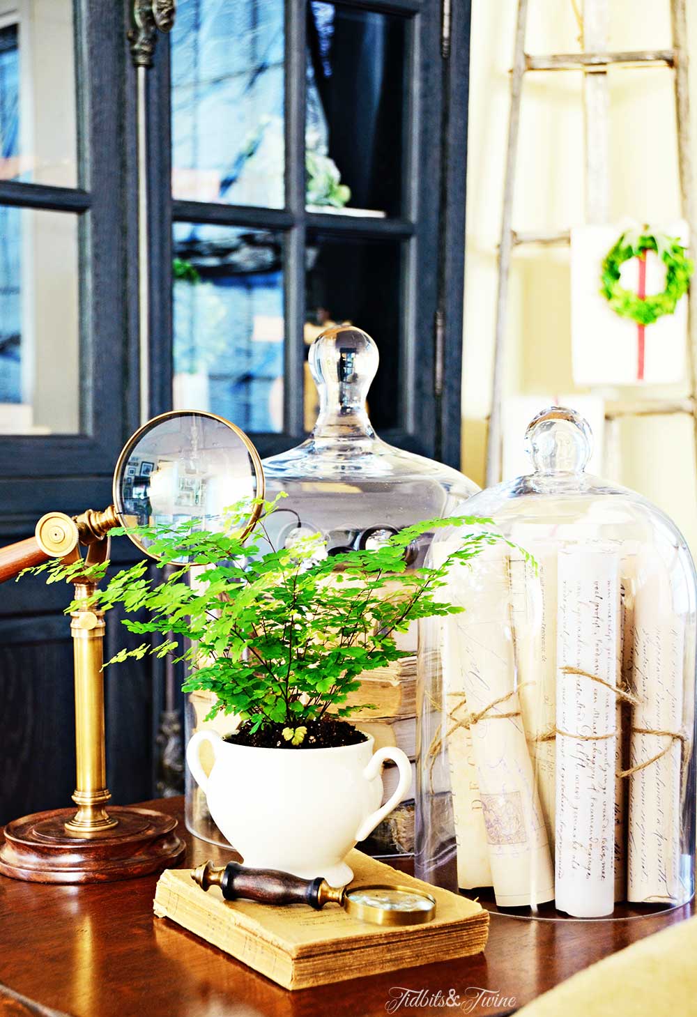 Side table with cloches filled with vintage books and letters