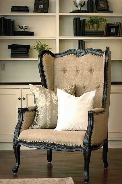 Black wingback upholstered in burlap with tufted back and nailhead trim