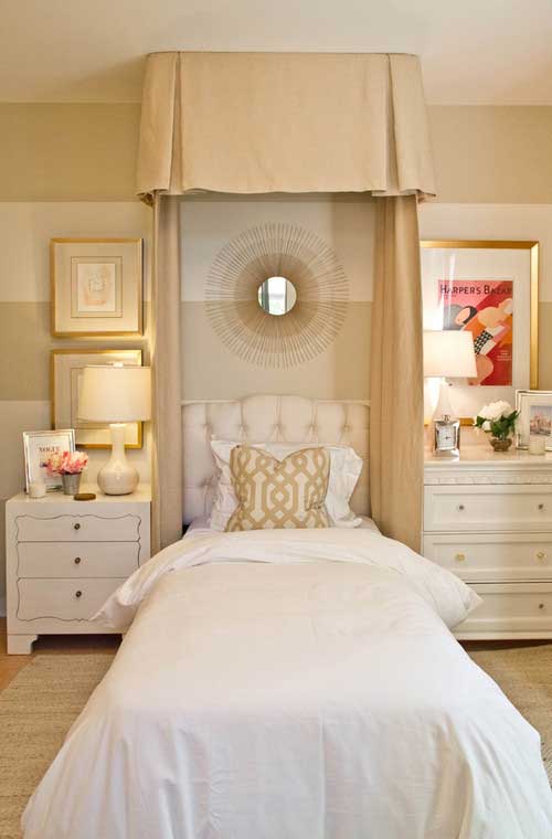 bedroom with tufted headboard and bed canopy and mismatched nightstands