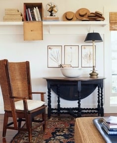 View of electric lamp and picture frame with armchair