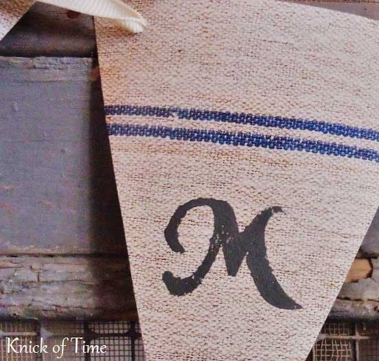 Closeup picture of a blue stripe vintage grain sack that has been made into a banner