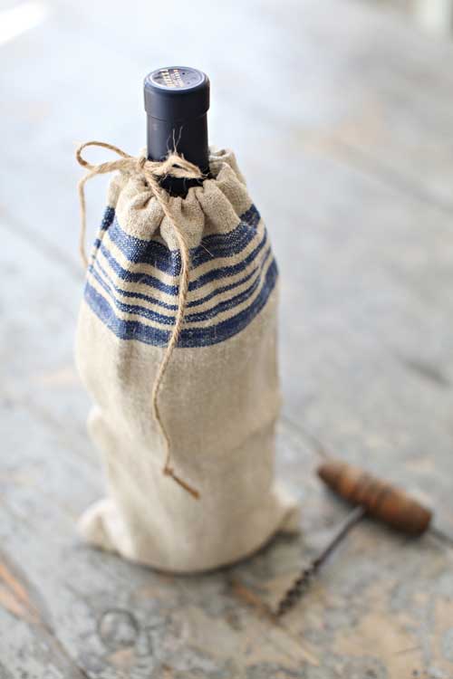 Close up of blue stripe vintage grain sack wine bottle bag