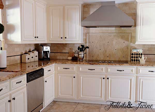 1980s tuscan kitchen with brown granite countertop and travertine backsplash