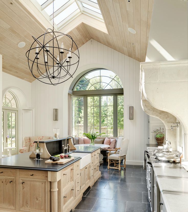 Kitchen with vaulted birch planked ceiling and white planked walls