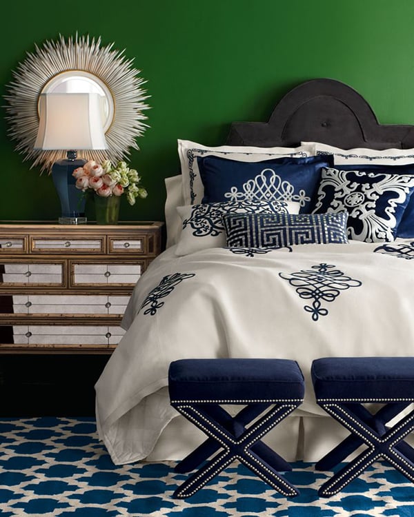 Bedroom with green walls and navy blue and white bedding