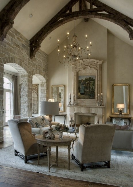 Formal European living room with stone walls and wooden beam arches
