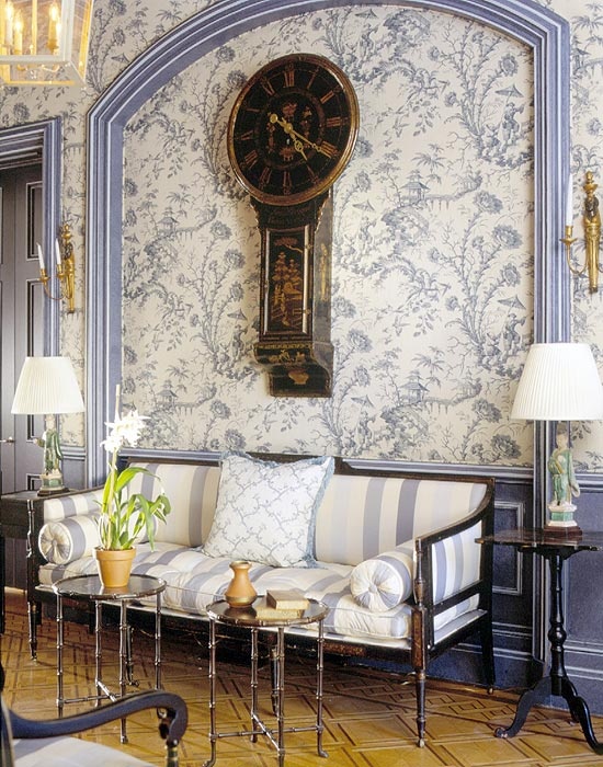 formal french blue stripe settee with blue toile wallpaper and blue wainscotting and wood floors