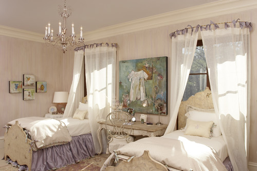 A French style bedroom with twin beds and with bed crowns and purple bedskirts