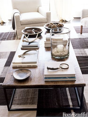 Industrial coffee table with books antlers and a candle on top