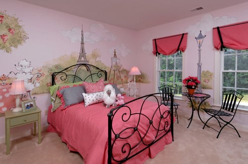 A Parisian themed girls bedroom with pink Eiffel tower mural and black accents