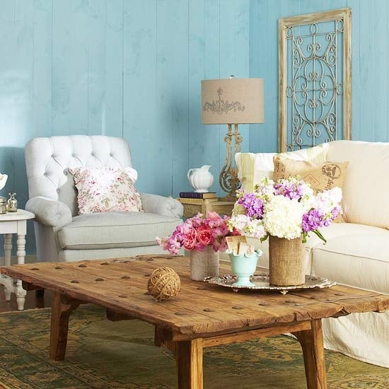 French country living room rustic coffee table with two flower arrangements on top