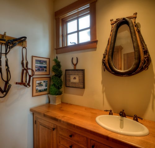 Western themed bathroom with yolk mirror and harnesses on the wall