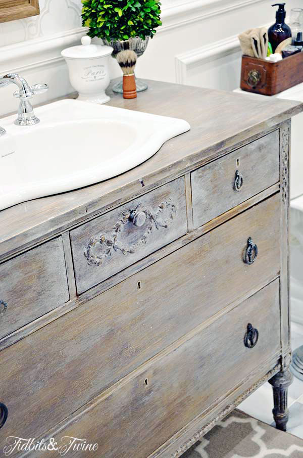 French wooden dresser turned into a bathroom vanity with marble floors