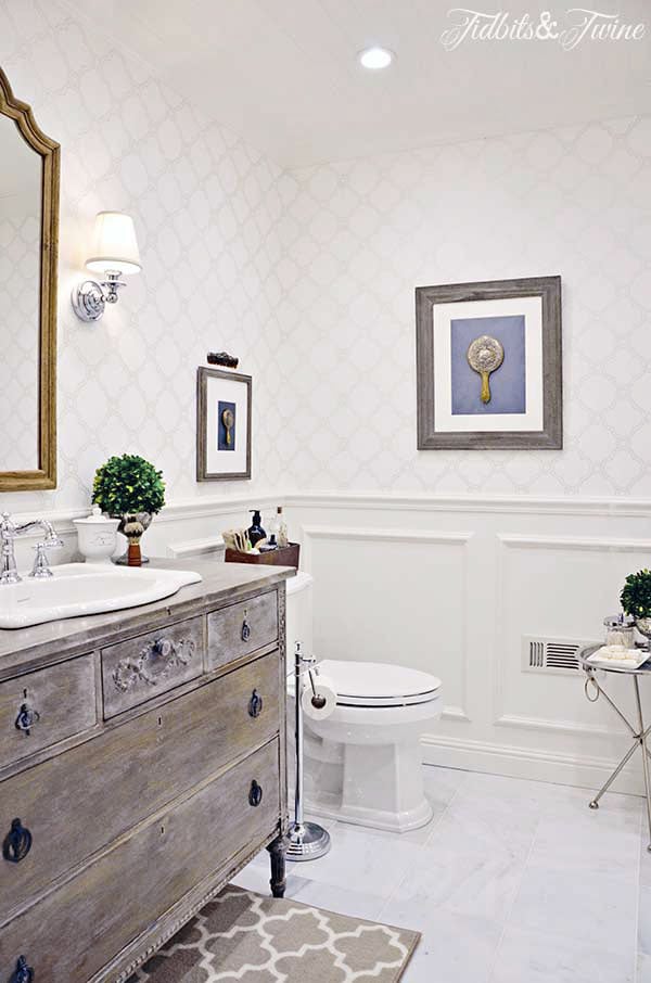 bathroom makeover with dresser vanity trellis wallpaper beadboard ceiling and carrara marble