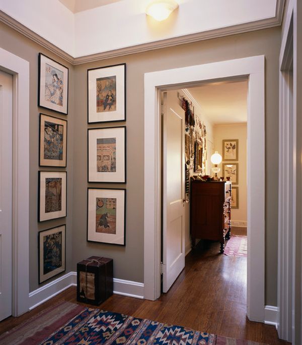 beige hallway with black framed artwork hanging vertically to fill the empty corner