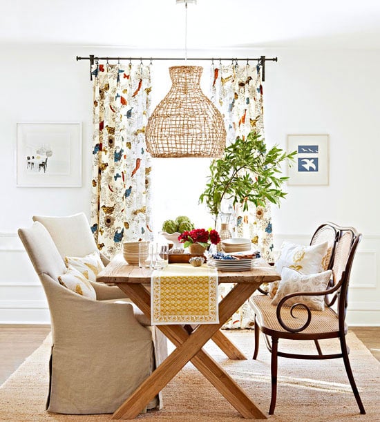 white dining room with bench on one side and upholstered chairs on the other