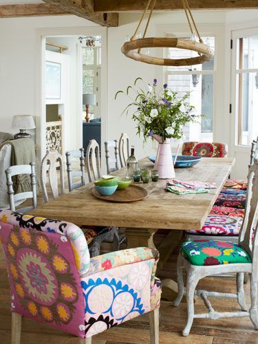 Dining room with trestle table and mixed french dining chairs with bold prints