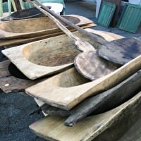 stack of large european antique dough bowls on the ground