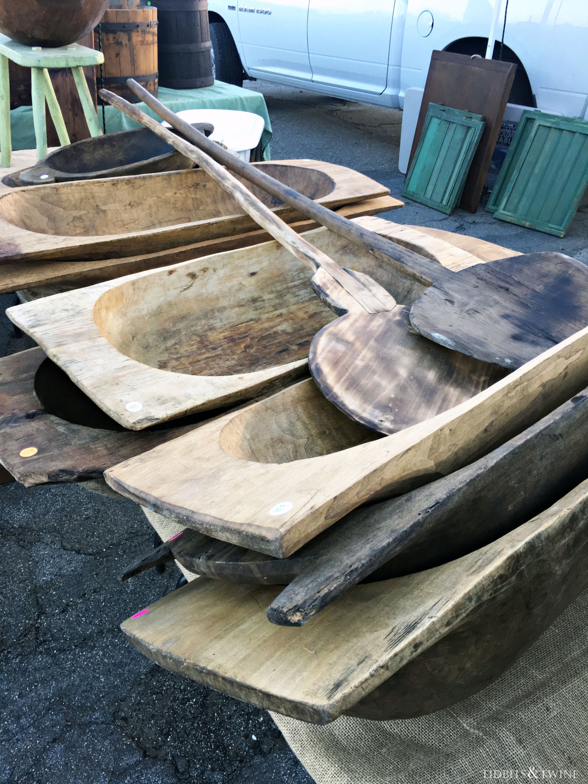 stack of large european antique dough bowls on the ground