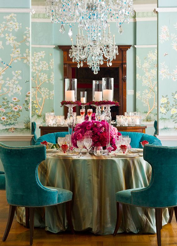 Blue wallpaper in a dining room with blue seating and pink roses