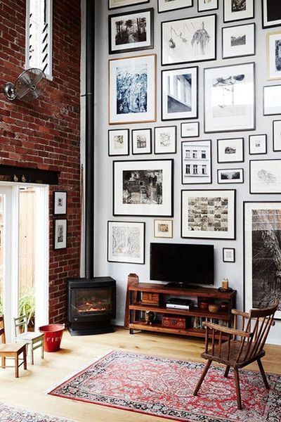 Tall walls with eclectic gallery wall exposed brick and corner fireplace