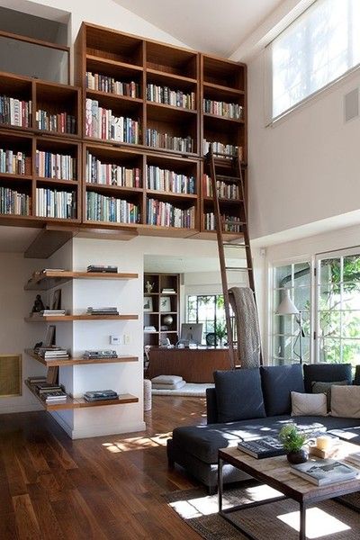 Brown modern bookcase floating on a wall with a ladder to reach the books