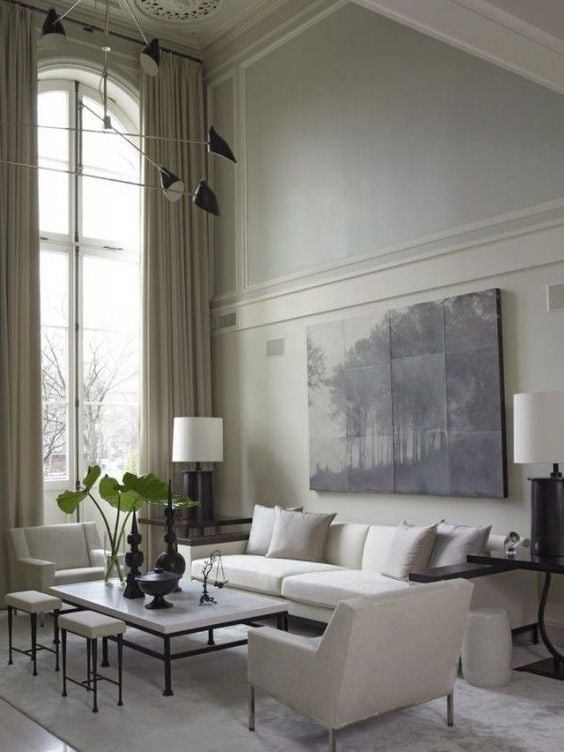 Soft blue living room with arched windows and white contemporary furniture