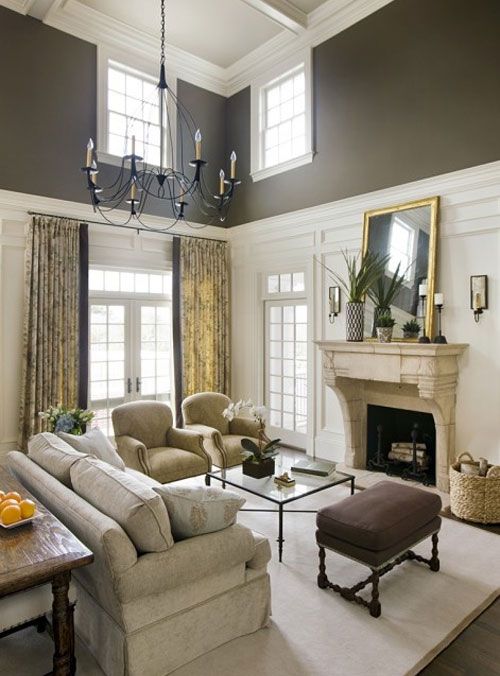 Vaulted living room with white trim on bottom and brown walls on top