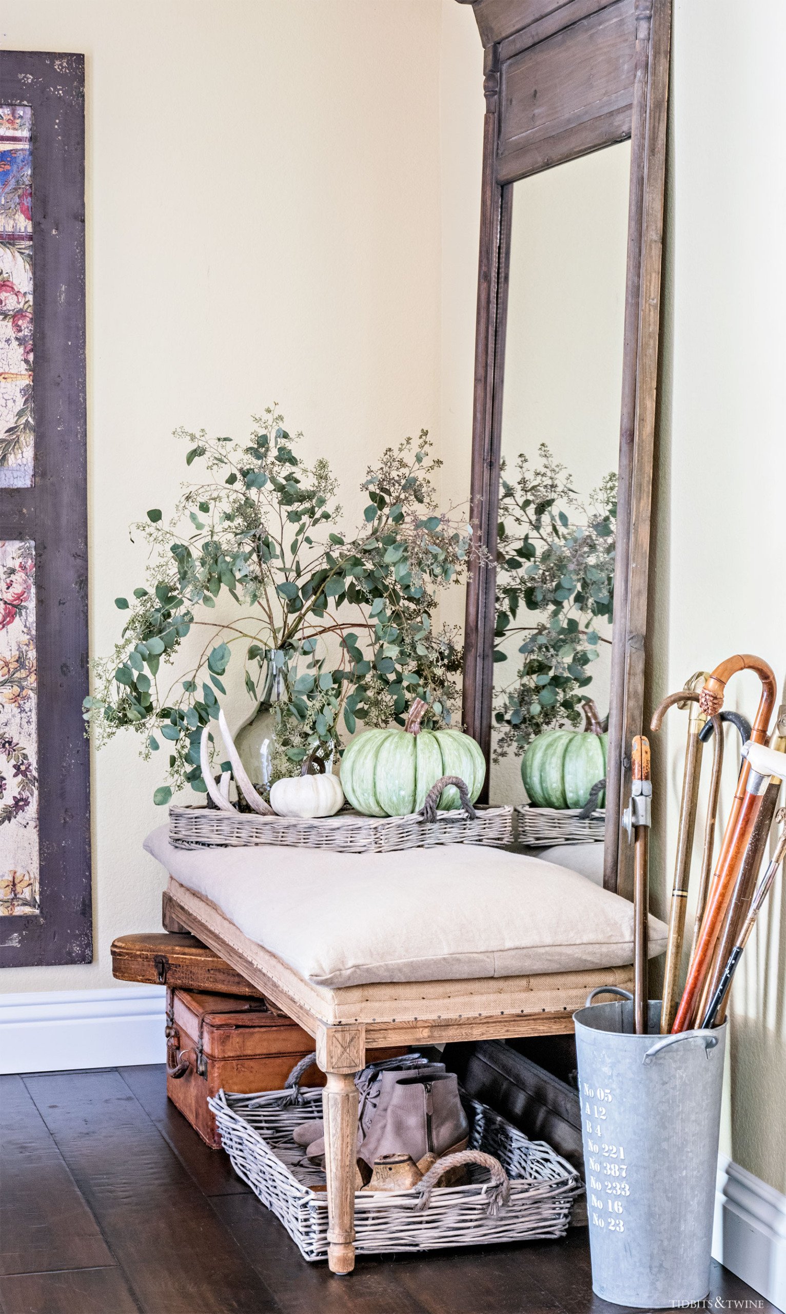 French Farmhouse foyer entryway decorated for fall with large wooden mirror and burlap bench