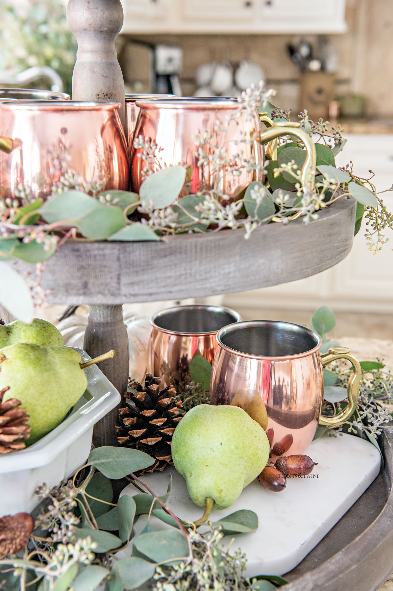 Farmhouse tray decorated for fall with eucalyptus and copper accents