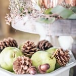 tiered kitchen tray with white ironstone bowl fulls of pears and pinecones with copper mugs and eucalyptus on tier above