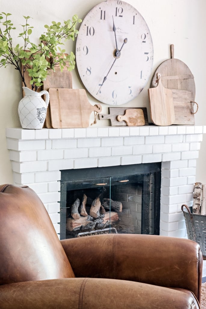 wooden cutting board collection on mantel - How to Decorate with Antiques