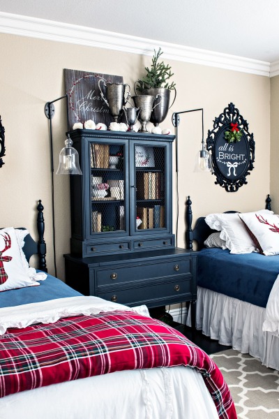 bedroom with twin beds decorated for Christmas with red plaid, black furniture