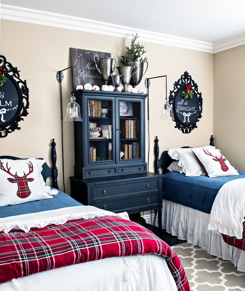 bedroom with twin beds decorated for Christmas with red plaid, black furniture