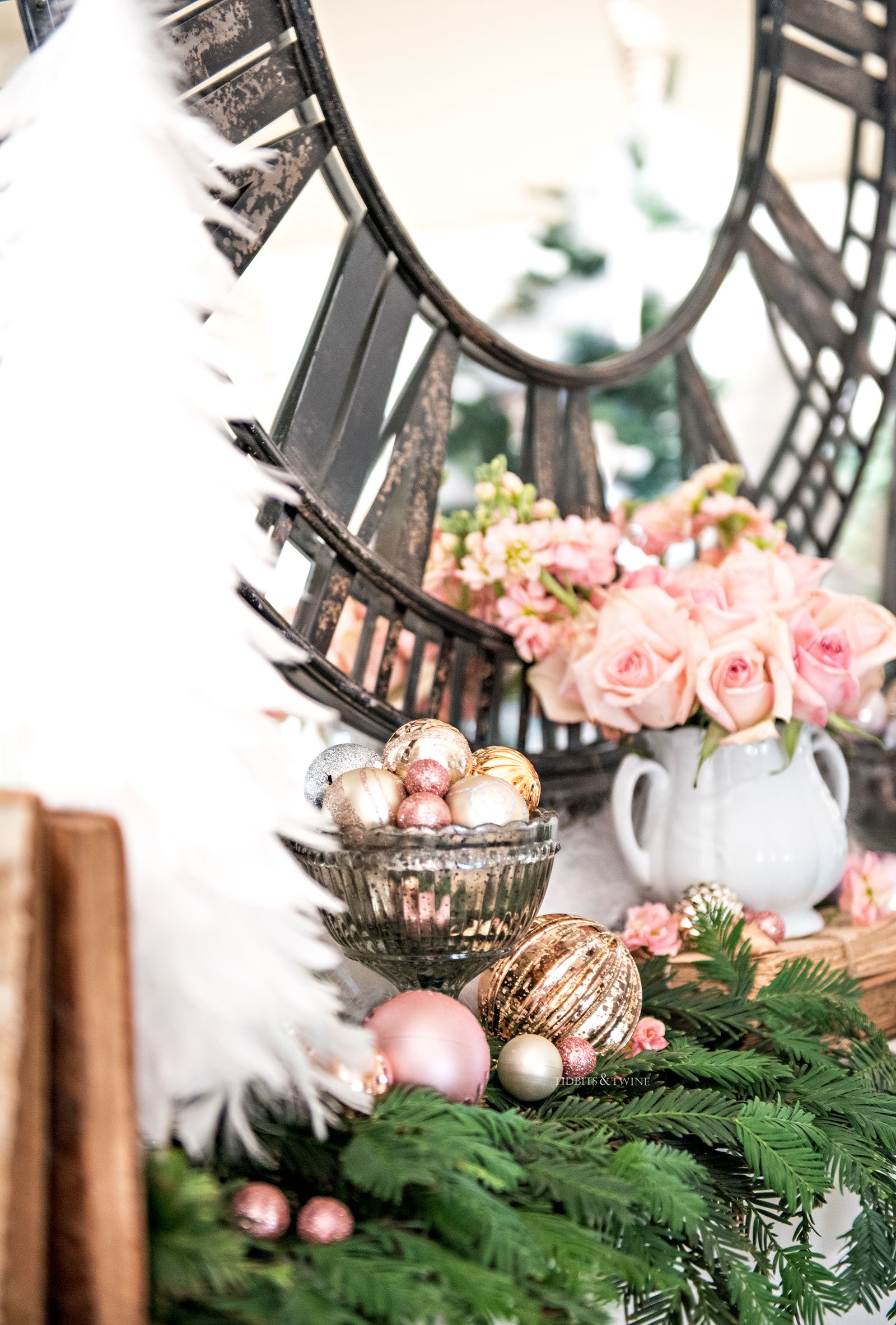 Fireplace mantel with white feather Christmas tree decorated with pink ornaments and roses