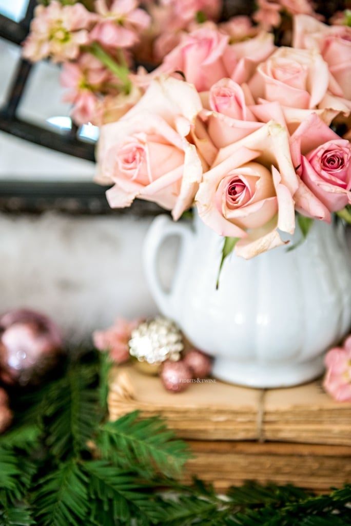 Pink roses in an antique ironstone sugar bowl on fireplace mantel