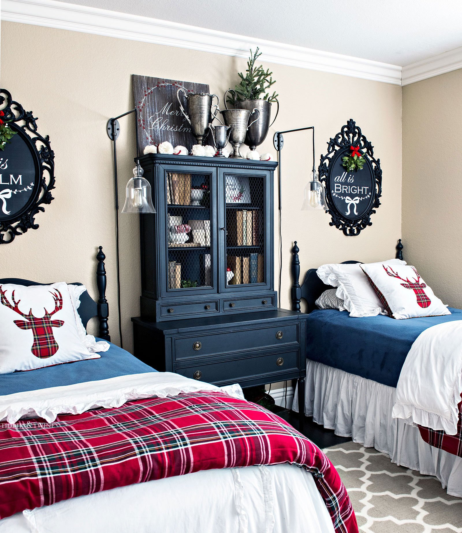 Blue red and green guest bedroom with two twin beds and vintage black furniture