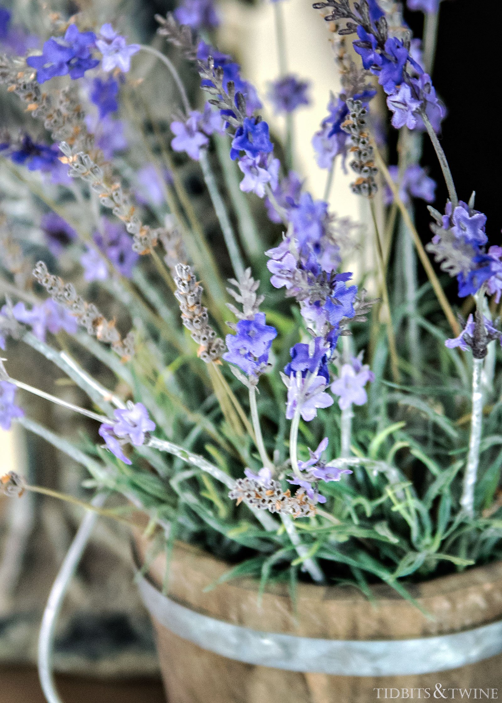 closeup Mix of real and fake lavender in a wooden bucket pot