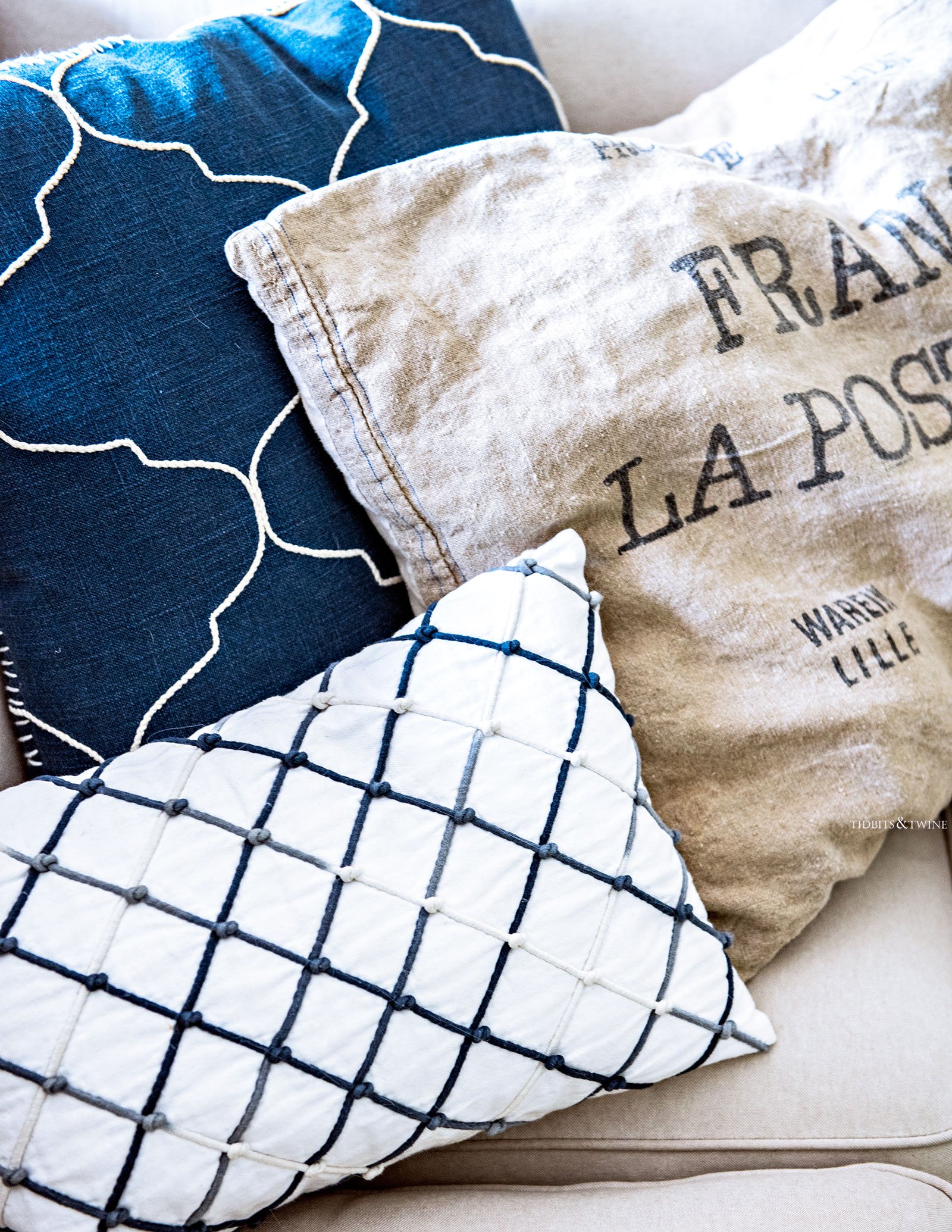 Blue and white French pillows with an additional grain sack pillow