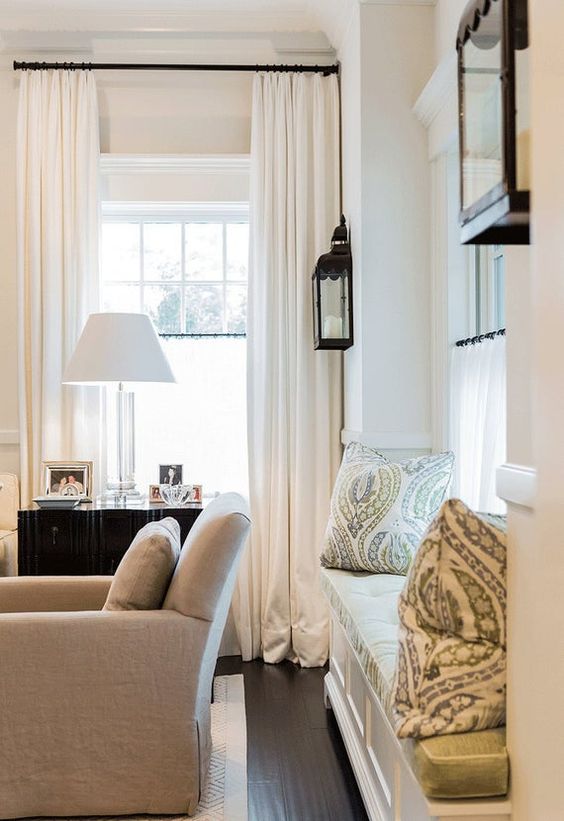 Family room with window seat and white curtains