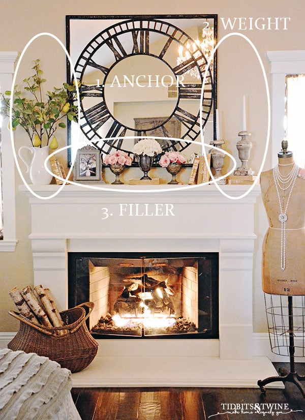 White fireplace mantel with mirror clock above candlesticks and books