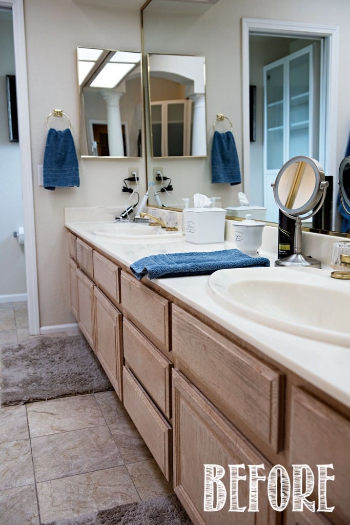 cultured marble bathroom vanity with oak cabinets and gold fixtures