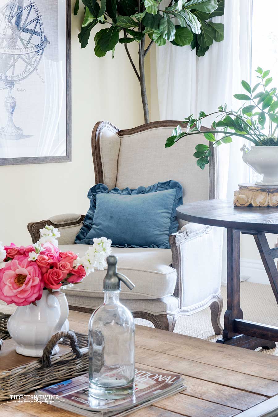 French wingback chair with blue ruffle pillow