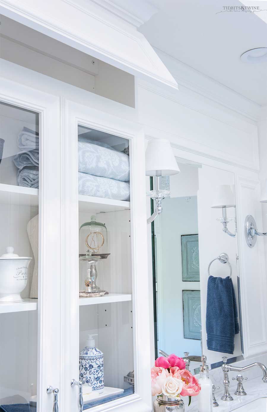 Hidden cabinet storage on white bathroom vanity