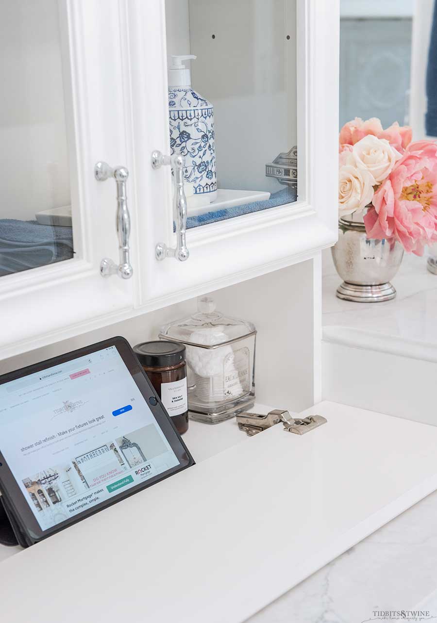 Bathroom vanity with ipad storage in drop down hidden panel