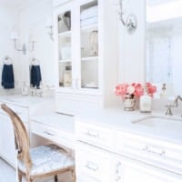 White master bathroom vanity with makeup area and sconces