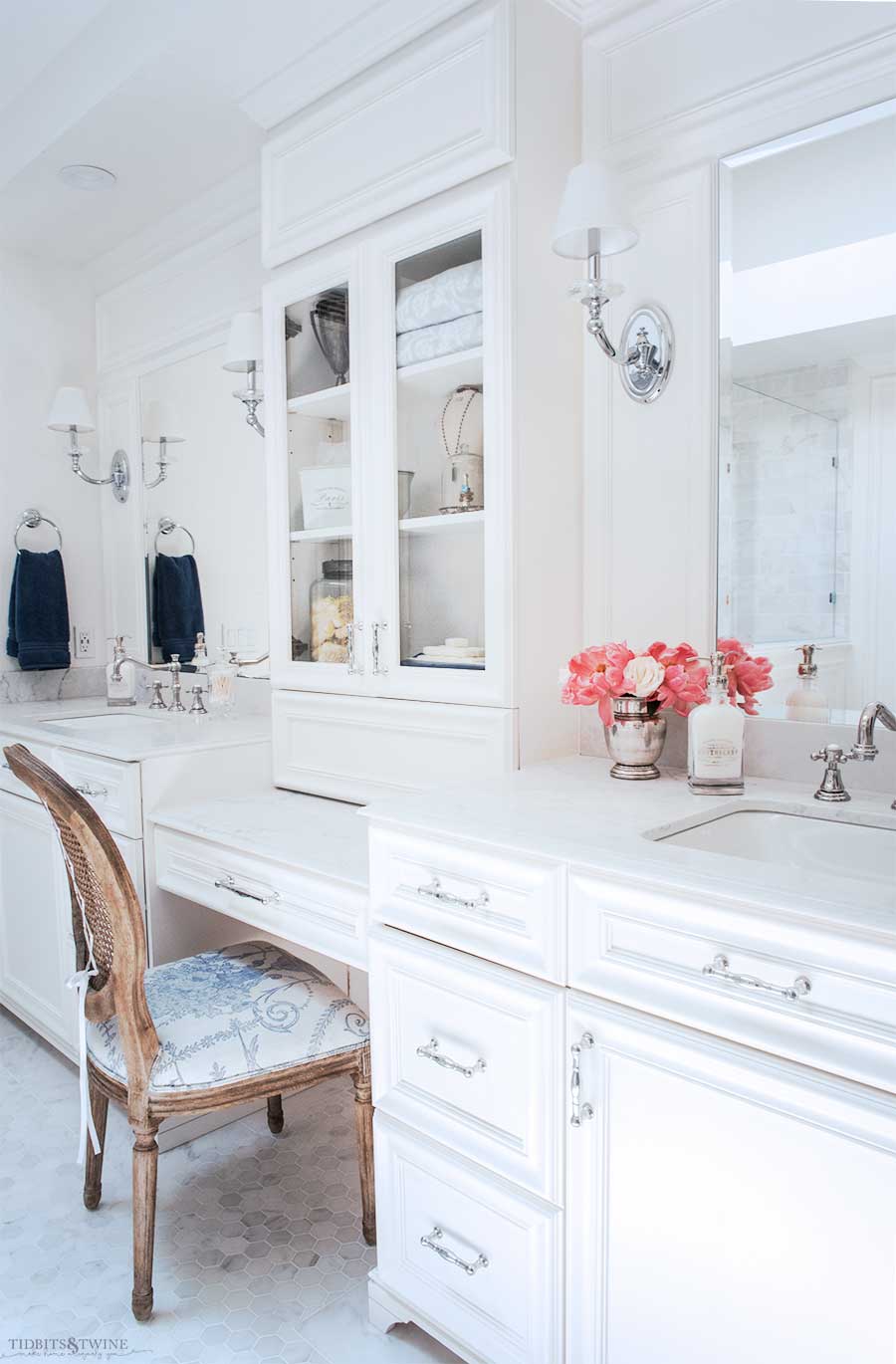 White French master bathroom two sink vanity with makeup area and sconces and hexagon carrara tile floor