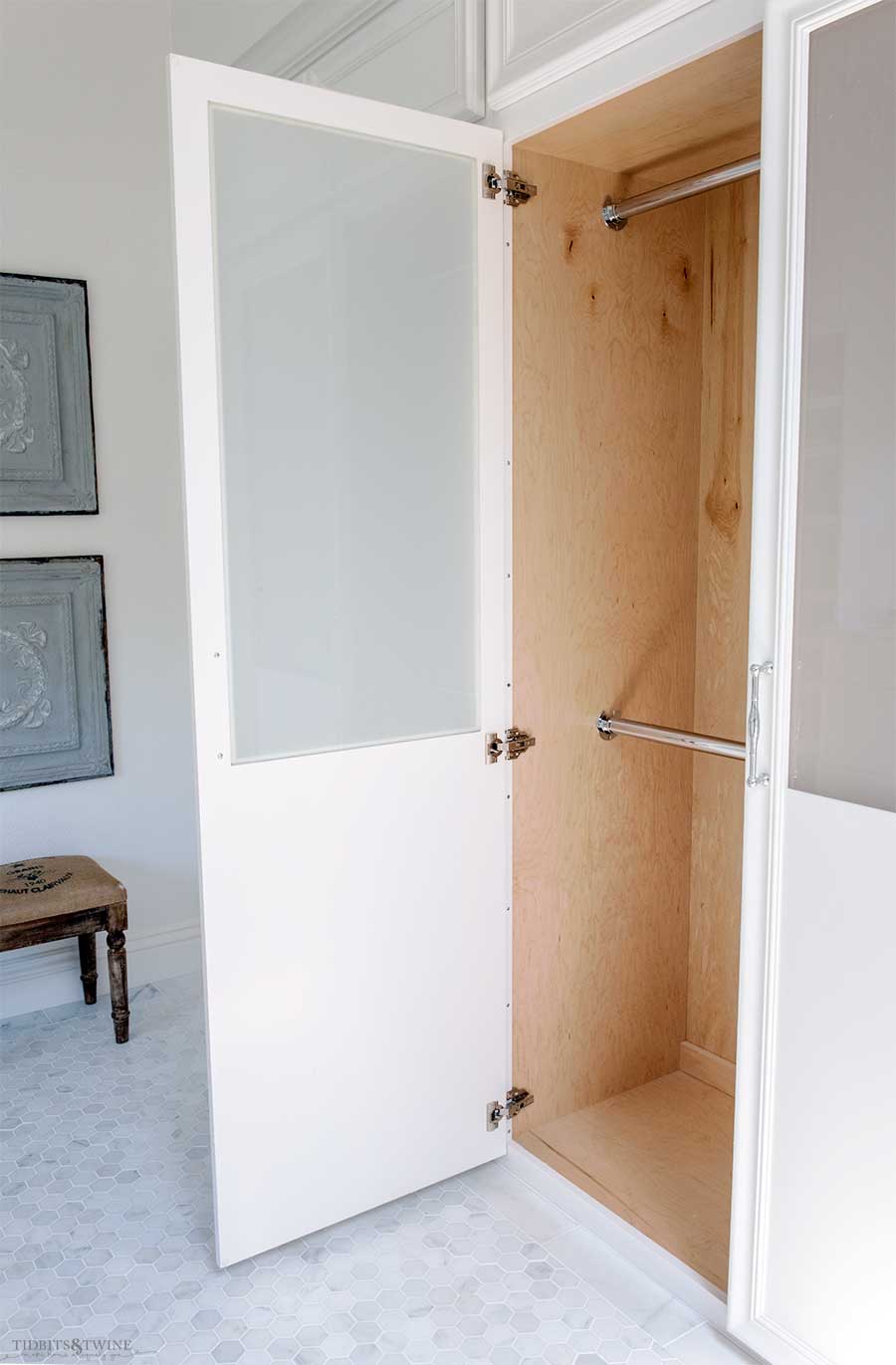 Bathroom with built-in closet with two bars