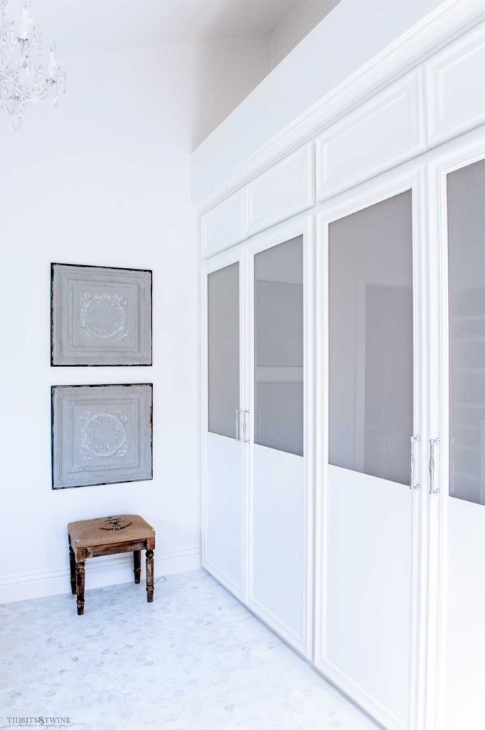 French elegant master bathroom with built in closets and antique tin ceiling tiles