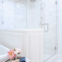 French master bathroom with carrara shower pony wall next to freestanding tub